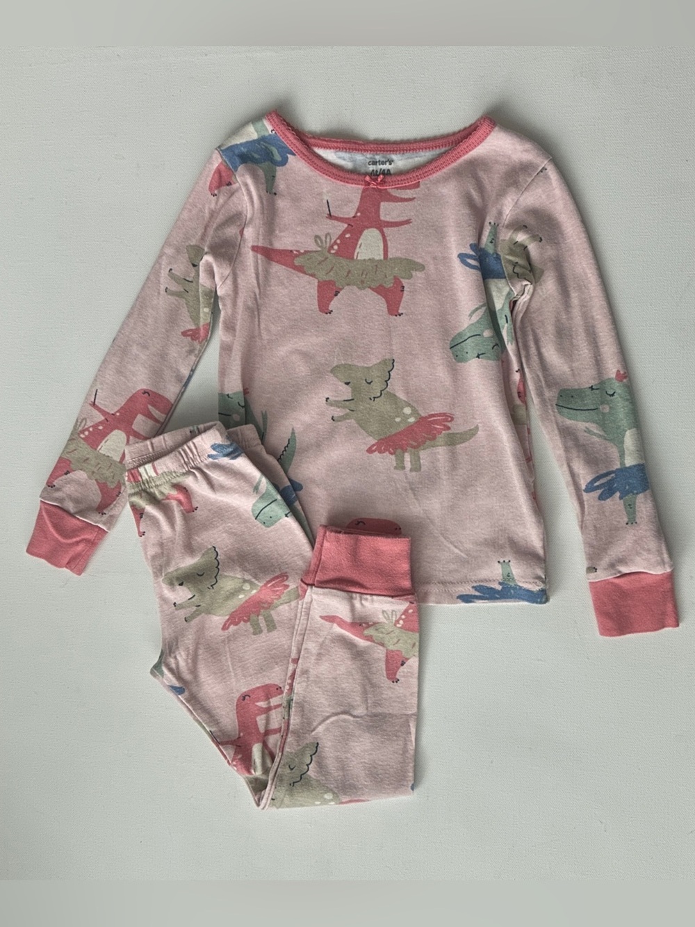 Carter's girl’s pajama set pattern of colorful dinosaurs, tutu ballet.  Size 4T.